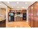A view of the kitchen, with wood floors and ample storage and stainless steel appliances at 2784 Cherrydale Falls Dr, Henderson, NV 89052