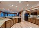 Open kitchen with granite countertops, custom cabinetry, modern appliances, and hardwood floors at 2784 Cherrydale Falls Dr, Henderson, NV 89052