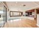 A spacious living room with beautiful hardwood floors, lots of natural light, and a built in fireplace at 2784 Cherrydale Falls Dr, Henderson, NV 89052