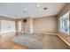 Bright living room with plush carpet, hardwood accents, and plenty of natural light at 2784 Cherrydale Falls Dr, Henderson, NV 89052