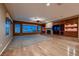 Large living room featuring hardwood floors, a ceiling fan and expansive lake views at 2784 Cherrydale Falls Dr, Henderson, NV 89052