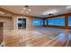 Open-concept living room with beautiful hardwood floors and large windows overlooking the water at 2784 Cherrydale Falls Dr, Henderson, NV 89052