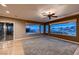 Spacious living room featuring hardwood floors, neutral carpeting, and large windows boasting scenic views at 2784 Cherrydale Falls Dr, Henderson, NV 89052