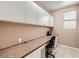 Home office with desk, cabinets, neutral paint and tile flooring at 2784 Cherrydale Falls Dr, Henderson, NV 89052
