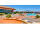 Community pool area with lounge chairs, tables and umbrellas, showcasing a great outdoor space with mountain views at 2784 Cherrydale Falls Dr, Henderson, NV 89052