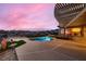 Backyard with a sparkling pool, hot tub, and synthetic grass at 2784 Cherrydale Falls Dr, Henderson, NV 89052