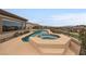 Private pool with a connected hot tub, desert landscape and scenic neighborhood views at 2784 Cherrydale Falls Dr, Henderson, NV 89052