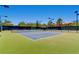 Wide shot of well maintained tennis court with green fencing and lighting for evening play at 2784 Cherrydale Falls Dr, Henderson, NV 89052