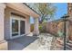 Charming back patio with tile flooring and a landscaped garden area creates a peaceful outdoor retreat at 2889 Anteres St, Las Vegas, NV 89117