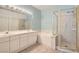 Bathroom featuring double sinks, a bathtub, and a separate shower with a glass enclosure at 2889 Anteres St, Las Vegas, NV 89117