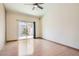 Bright bedroom features sleek wood floors and a sliding glass door providing access to the outdoors at 2889 Anteres St, Las Vegas, NV 89117