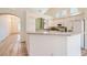 Bright kitchen with white cabinets, tile flooring, granite countertops and stainless appliances at 2889 Anteres St, Las Vegas, NV 89117