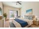 Staged main bedroom featuring a sliding door to the backyard and light, modern decor at 2889 Anteres St, Las Vegas, NV 89117
