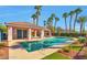 Community pool with covered cabana, chairs, palm trees, and artificial turf at 2889 Anteres St, Las Vegas, NV 89117