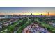 Aerial view featuring the Las Vegas skyline, golf course, residential area, and mountain backdrop at sunset at 3111 Bel Air Dr # 23A, Las Vegas, NV 89109