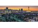 Las Vegas aerial view showcases the city skyline, golf course, and iconic landmarks at sunset at 3111 Bel Air Dr # 23A, Las Vegas, NV 89109