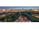A beautiful aerial view shows the city skyline at night, with a golf course and residential homes at 3111 Bel Air Dr # 23A, Las Vegas, NV 89109