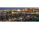Nighttime aerial of Las Vegas skyline, golf course, and residential areas with bright city lights at 3111 Bel Air Dr # 23A, Las Vegas, NV 89109