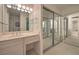 Bathroom features a long vanity with mirror and a separate mirrored closet area at 3111 Bel Air Dr # 23A, Las Vegas, NV 89109