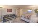 Well-lit bedroom features a bed, couch, wardrobe, and vanity mirror atop dresser at 3111 Bel Air Dr # 23A, Las Vegas, NV 89109