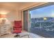 Cozy sitting area with a fantastic cityscape view from the bedroom's sliding glass door at 3111 Bel Air Dr # 23A, Las Vegas, NV 89109