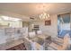 Eat-in dining area with glass table, seating for six, bar access, and a vintage chandelier at 3111 Bel Air Dr # 23A, Las Vegas, NV 89109