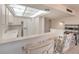 Bright kitchen with a pass-through to the dining area, white cabinets, and tile floors at 3111 Bel Air Dr # 23A, Las Vegas, NV 89109