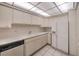 Bright kitchen with white cabinets, tile floors, double sinks, and modern appliances at 3111 Bel Air Dr # 23A, Las Vegas, NV 89109