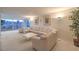 Spacious living room with neutral tones, a large sofa, and a city view from the balcony at 3111 Bel Air Dr # 23A, Las Vegas, NV 89109