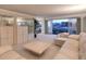 Bright living room with sleek furniture, display cases, and a sliding glass door to a balcony with a city view at 3111 Bel Air Dr # 23A, Las Vegas, NV 89109
