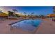 Inviting swimming pool at dusk with lounge areas and palm trees, perfect for relaxation at 3111 Bel Air Dr # 23A, Las Vegas, NV 89109