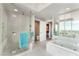 Spa-like bathroom featuring a glass shower, soaking tub, and city views at 322 Karen Ave # 2201, Las Vegas, NV 89109