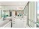 Bright bathroom with a large vanity, soaking tub, and floor-to-ceiling windows at 322 Karen Ave # 2201, Las Vegas, NV 89109