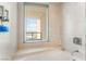 Bright bathroom with a soaking tub, tiled walls, and a city view at 322 Karen Ave # 2201, Las Vegas, NV 89109