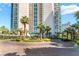 Elegant entrance with palm trees, manicured landscaping, and circular driveway at 322 Karen Ave # 2201, Las Vegas, NV 89109