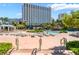 Beautiful pool with lots of lounge seating and lots of palm trees providing shade on a summer day at 322 Karen Ave # 2201, Las Vegas, NV 89109