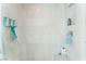 Bathroom shower boasts tiled walls, recessed shelving, and mounted dispensers at 322 Karen Ave # 2201, Las Vegas, NV 89109