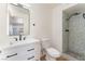 Modern bathroom with a gray tiled shower, white vanity, and updated fixtures at 3320 Osage Ave, Las Vegas, NV 89101
