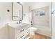 Bathroom features include a white vanity, a tub and shower combination with marble-style tiling, and black fixtures at 3320 Osage Ave, Las Vegas, NV 89101