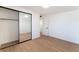Bedroom featuring wood floors, a mirrored closet, and a sleek ceiling fan at 3320 Osage Ave, Las Vegas, NV 89101