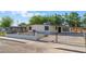Charming single-story home with white exterior, desert landscaping, and a secure iron fence at 3320 Osage Ave, Las Vegas, NV 89101