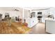 Staged kitchen boasts white cabinets, stainless appliances, and center island, seamlessly flowing into the adjacent living areas at 3320 Osage Ave, Las Vegas, NV 89101