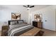 Staged bedroom with bed, ceiling fan, stylish furniture, wood floors, and modern accents at 3320 Osage Ave, Las Vegas, NV 89101