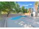 Large pool with a stone trim and ample patio space with tree coverage at 3320 Osage Ave, Las Vegas, NV 89101