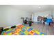 Basement with gray wood-look floors and a colorful alphabet playmat at 3360 National Ave, Pahrump, NV 89048