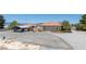 Single story home with an orange tile roof, covered parking, and basketball court at 3360 National Ave, Pahrump, NV 89048