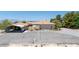 A single story home with orange tile roofing, desert landscaping, and covered parking at 3360 National Ave, Pahrump, NV 89048
