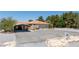 Charming ranch home with desert landscaping, orange tile roof and spacious driveway at 3360 National Ave, Pahrump, NV 89048