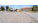 Exterior home featuring desert landscaping, covered parking and basketball court at 3360 National Ave, Pahrump, NV 89048