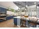 Open kitchen with two-tone cabinets, large island with seating, and wood-beam ceiling accent at 3360 National Ave, Pahrump, NV 89048